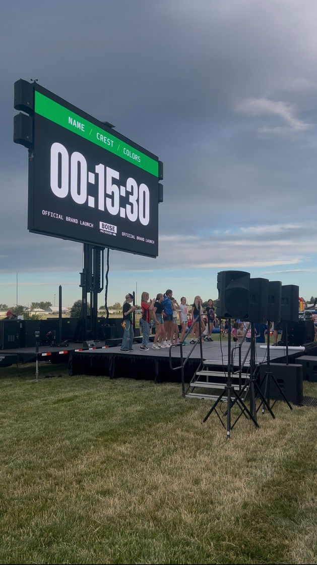 Soccer fans watching game on large LED screen